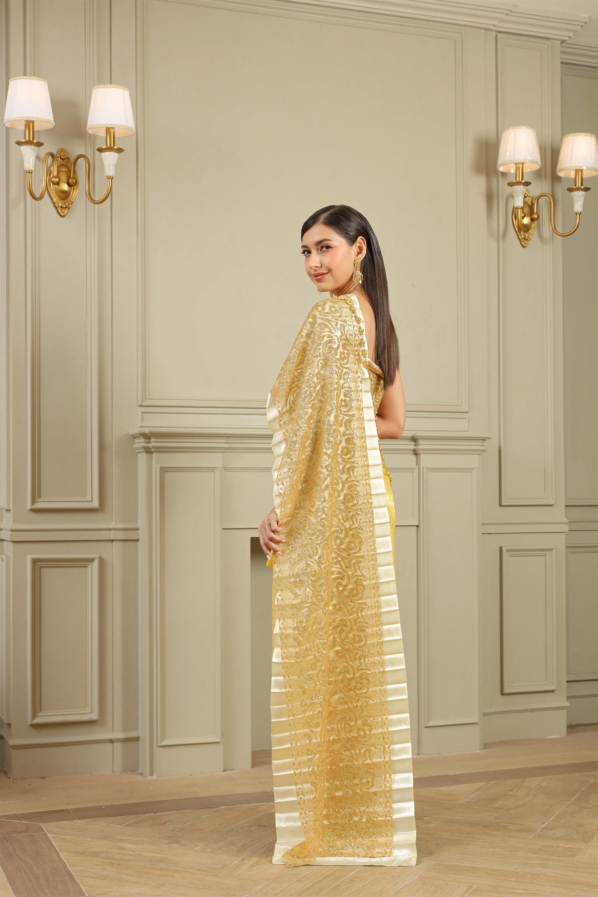A woman wearing a gold traditional Thai dress on her wedding day.