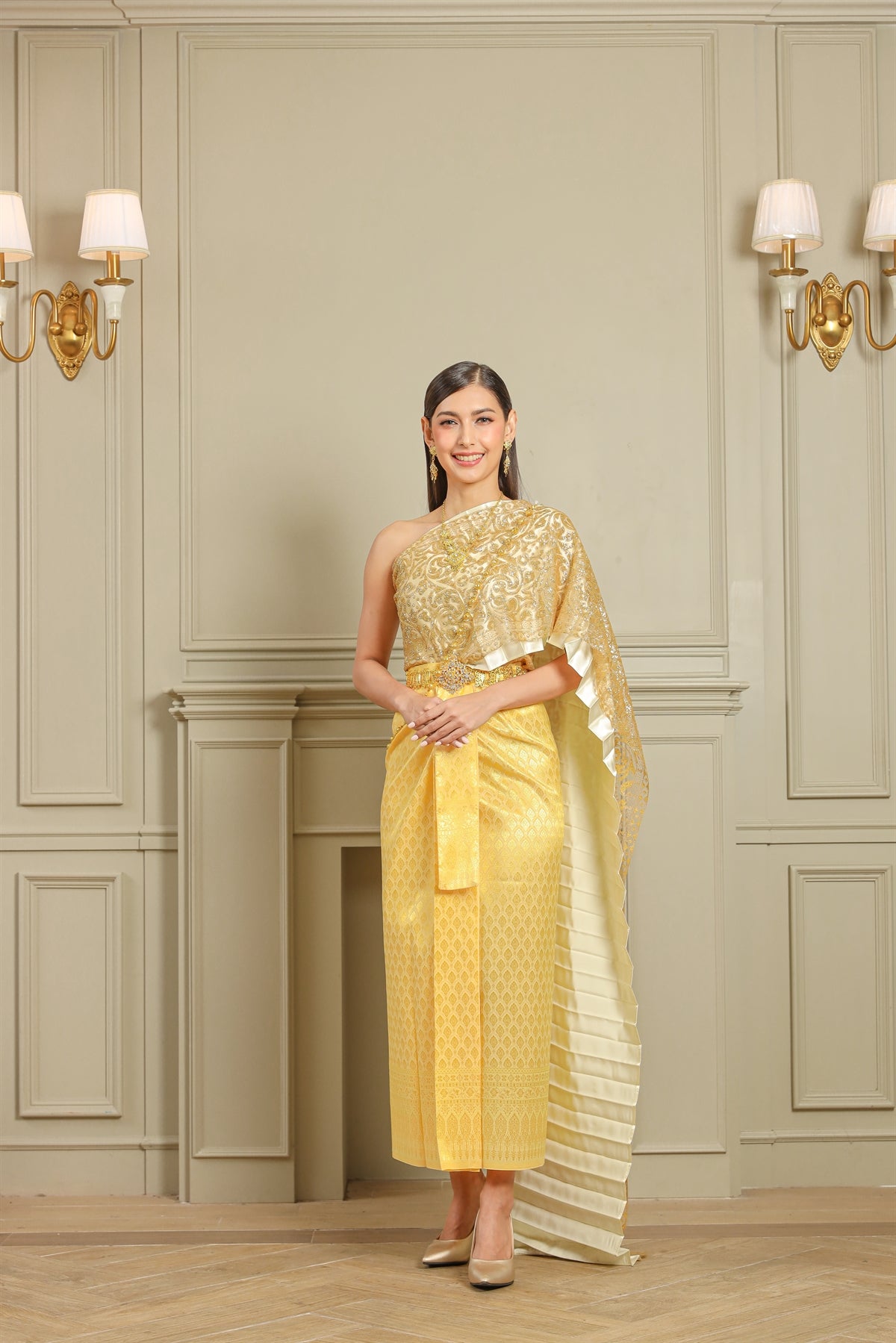 A happy woman smiles while dressed in Traditional Thai clothing on her wedding day.