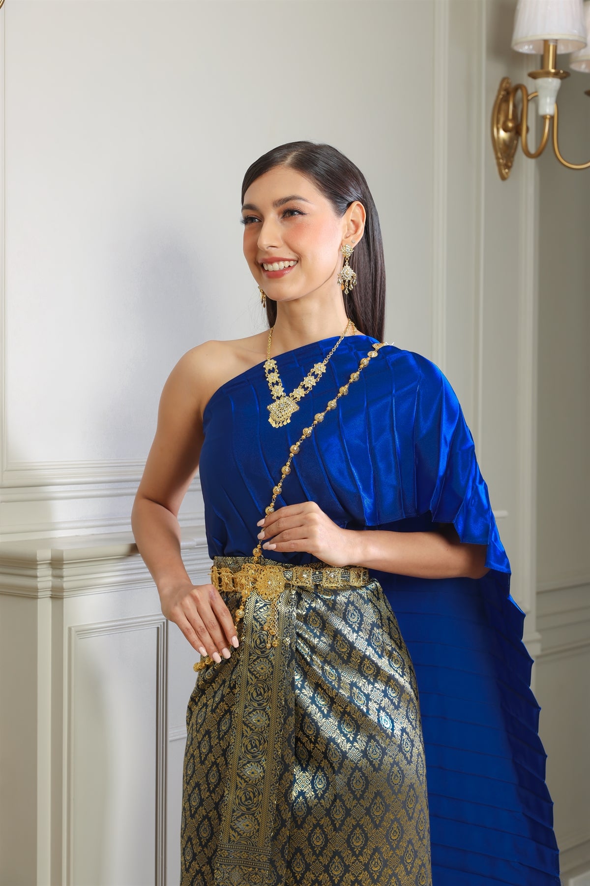 Picture of a woman posing in a beautiful blue traditional Thai dress